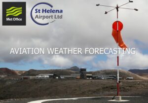 Photo of St Helena Airport in the background, and a wind sock in the foreground